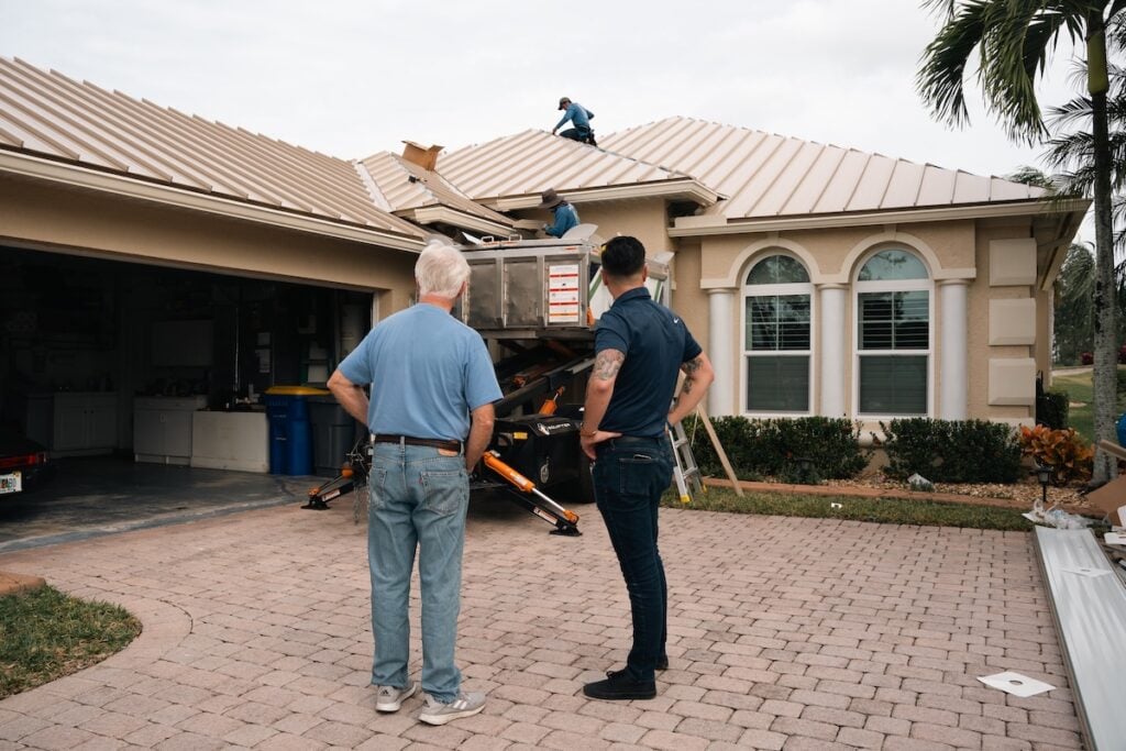 Employee with homeowner discussing roofing project