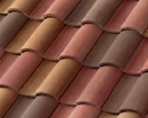 Close-up of overlapping clay roof tiles in shades of brown, tan, and reddish tones, arranged in a wavy pattern.