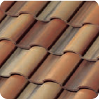 Close-up of overlapping, curved terracotta roof tiles in varying shades of brown, tan, and reddish-orange, arranged in a repeating wavy pattern.