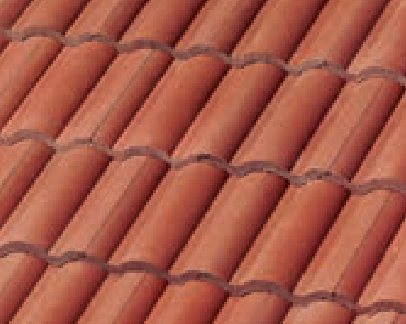 Close-up of red clay roof tiles arranged in a wavy, overlapping pattern, commonly seen on Mediterranean or Spanish-style buildings.