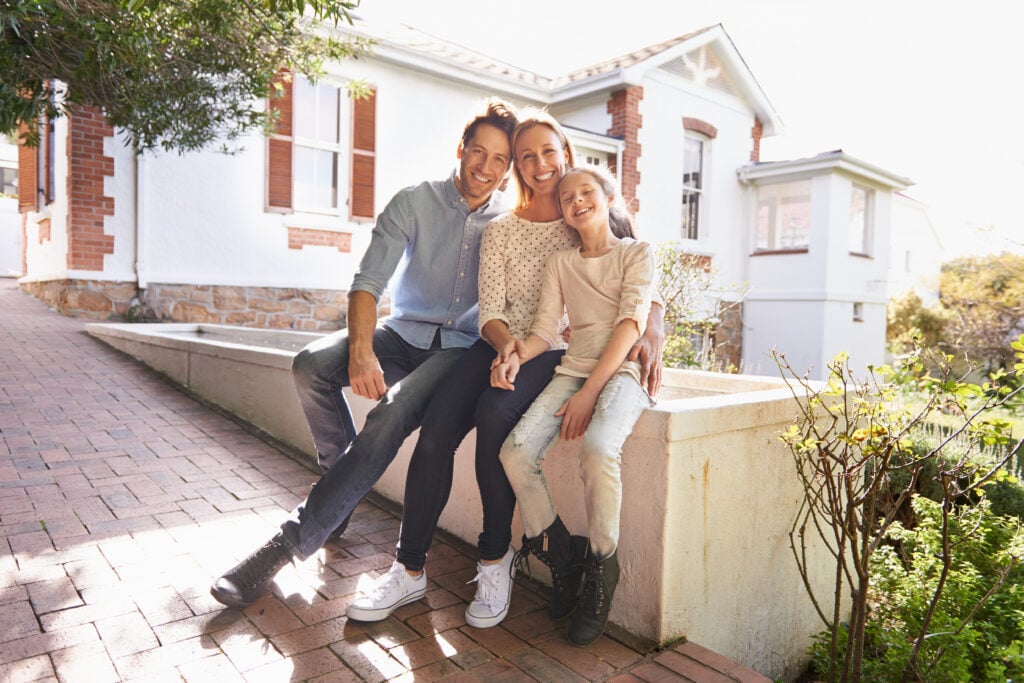 happy family in front of residential home