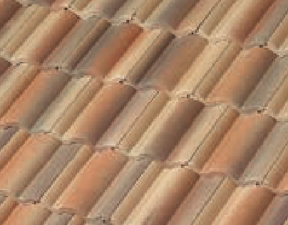 A close-up view of overlapping reddish-brown clay roof tiles arranged in a uniform, diagonal pattern.