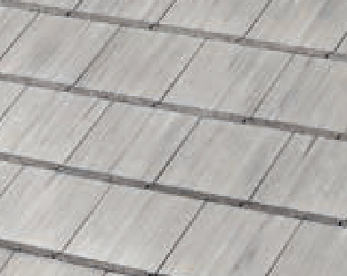 Close-up view of a roof with overlapping, rectangular, light gray shingles arranged in neat, horizontal rows.