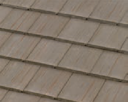 Close-up view of a roof with overlapping, rectangular, light brown shingles arranged in neat horizontal rows.