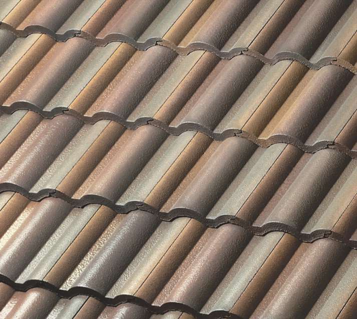 Close-up view of overlapping brown and tan ceramic roof tiles arranged in a wavy, repeating pattern, typical of a tiled roof.