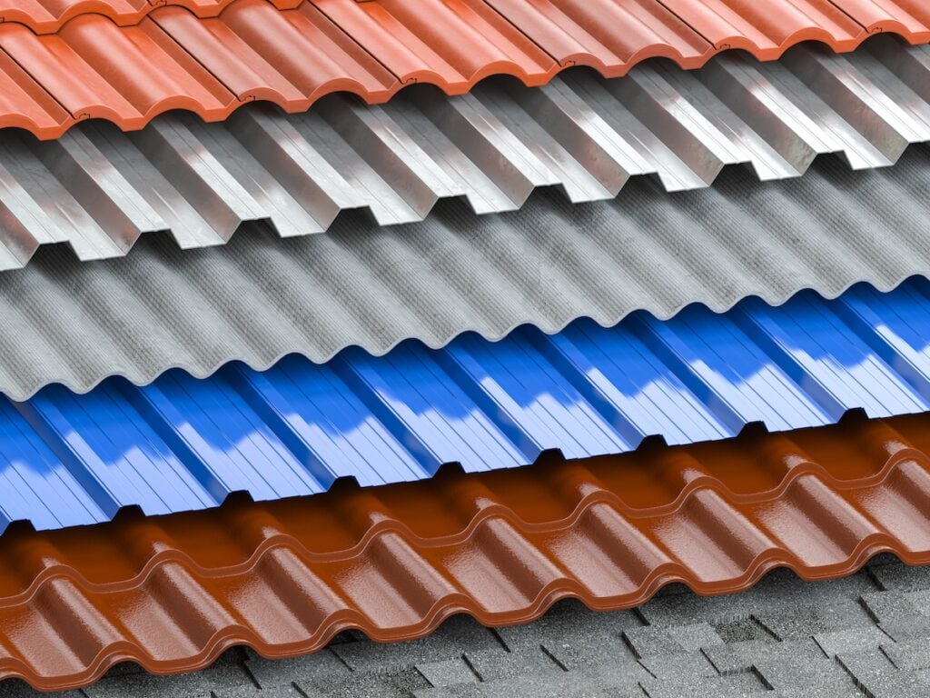 different types of roof shingles in red, gray, blue, and brown. Made of metal or similar material, the sheets feature a distinctive wavy pattern.