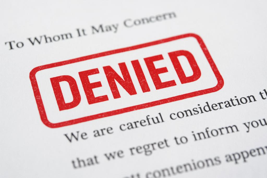 A letter with the large word "DENIED" stamped in red ink across the top, partially covering printed text that begins with "To Whom It May Concern.