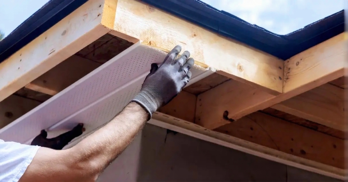 Roofing professionals replacing damaged fascia board on home exterior