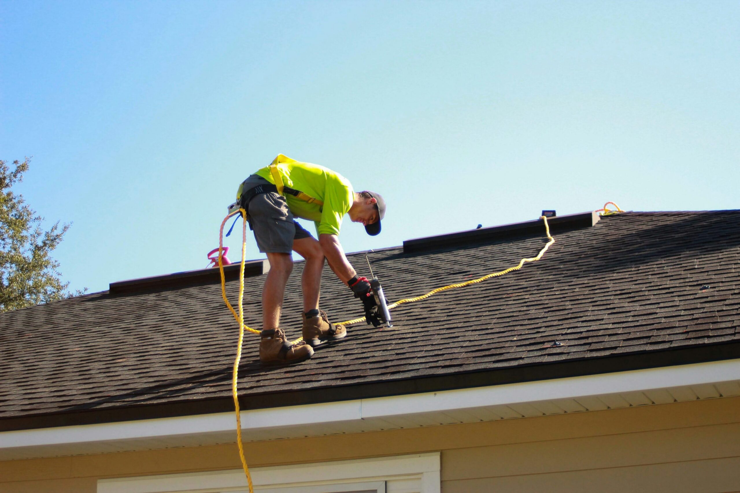 Professional roofers installing contemporary roofing materials on modern home