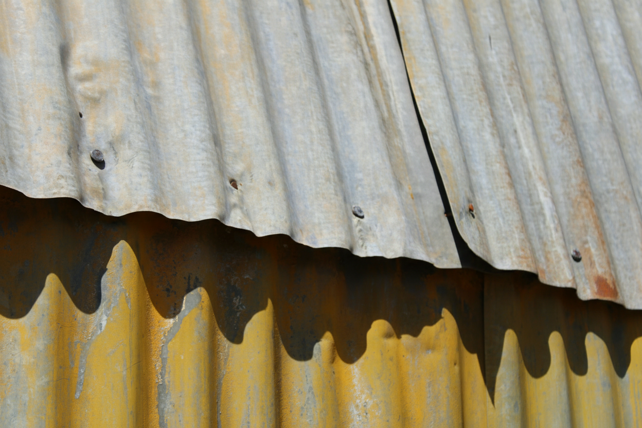 Homeowner and roofing contractor comparing different corrugated metal roofing material samples