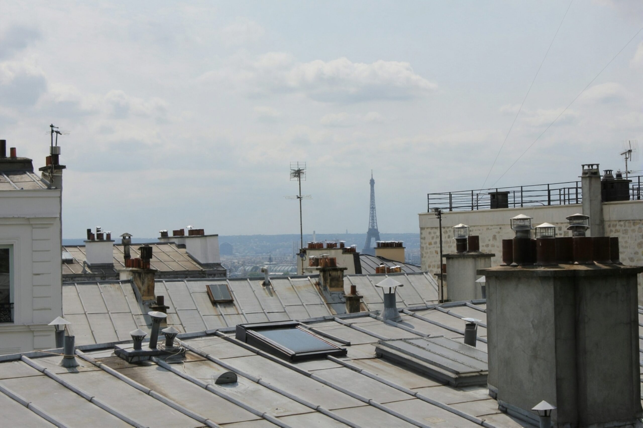Commercial property manager and roofing contractor inspecting a black EPDM flat roof on a business building
