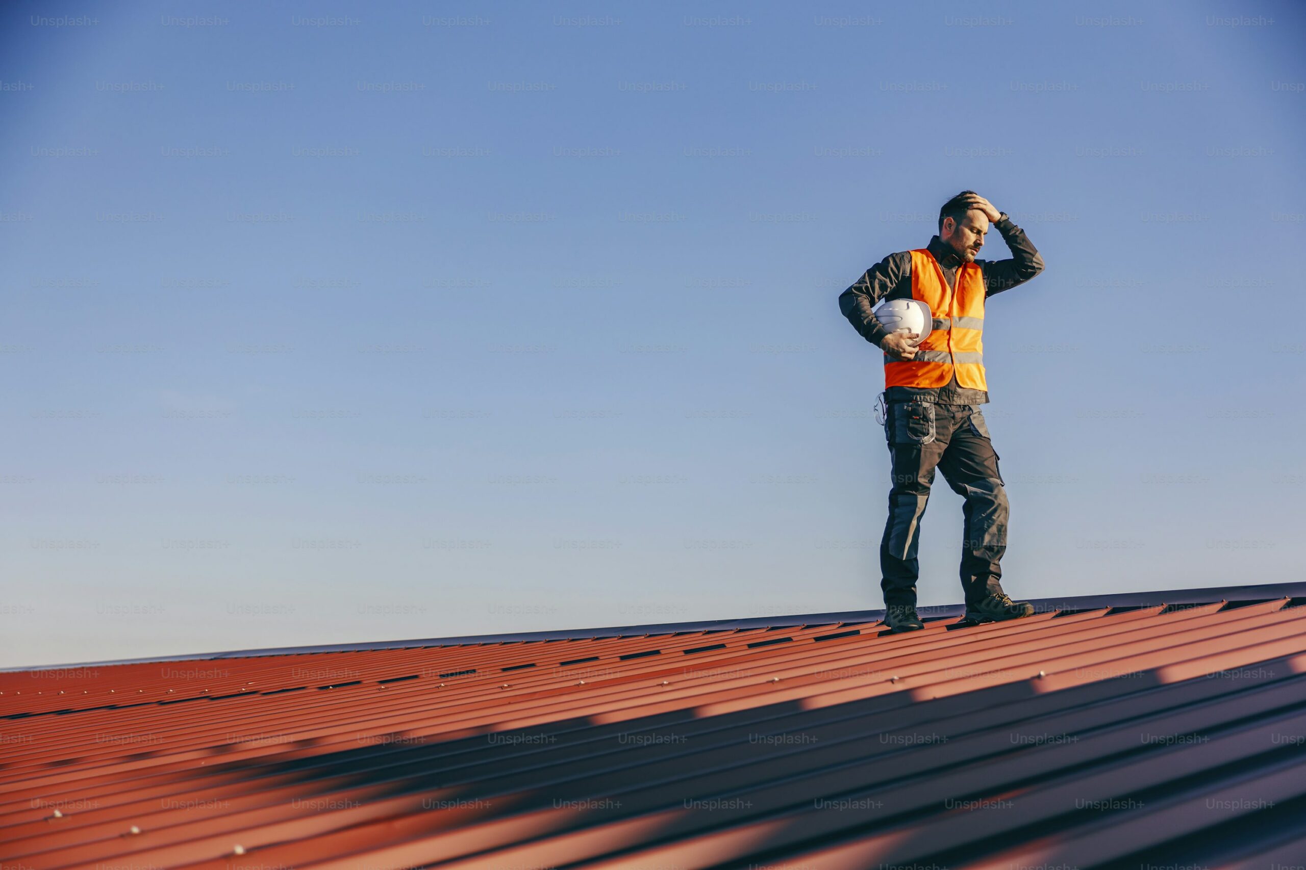 Homeowner and roofing contractor standing near a ladder discussing roof inspection findings and maintenance needs