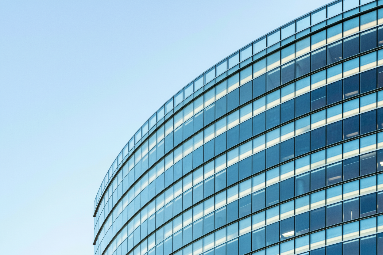Modern commercial building featuring a sleek flat concrete roof with people walking near the entrance, showcasing the aesthetic appeal