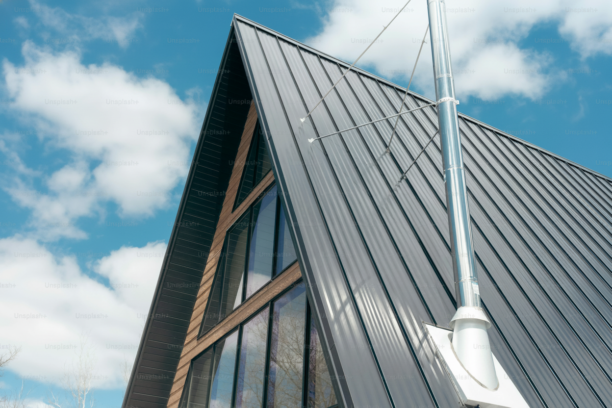 Contemporary home featuring a stylish colored metal roof with people standing in the front yard admiring the property