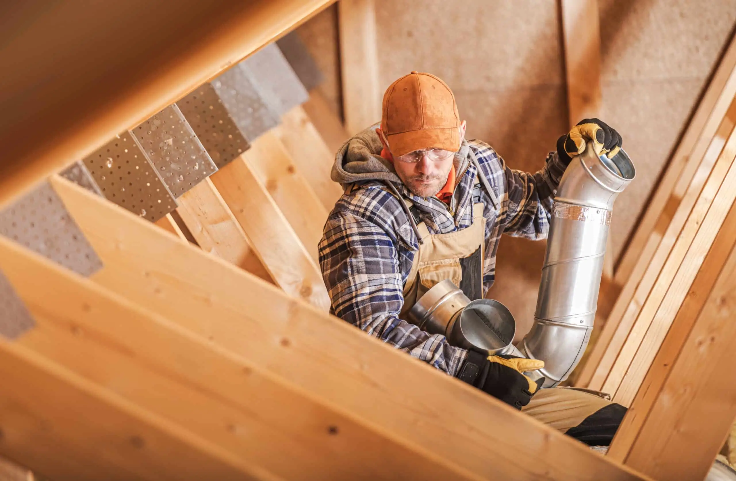 Roofing professionals installing modern roof ventilation system on home, demonstrating proper installation techniques