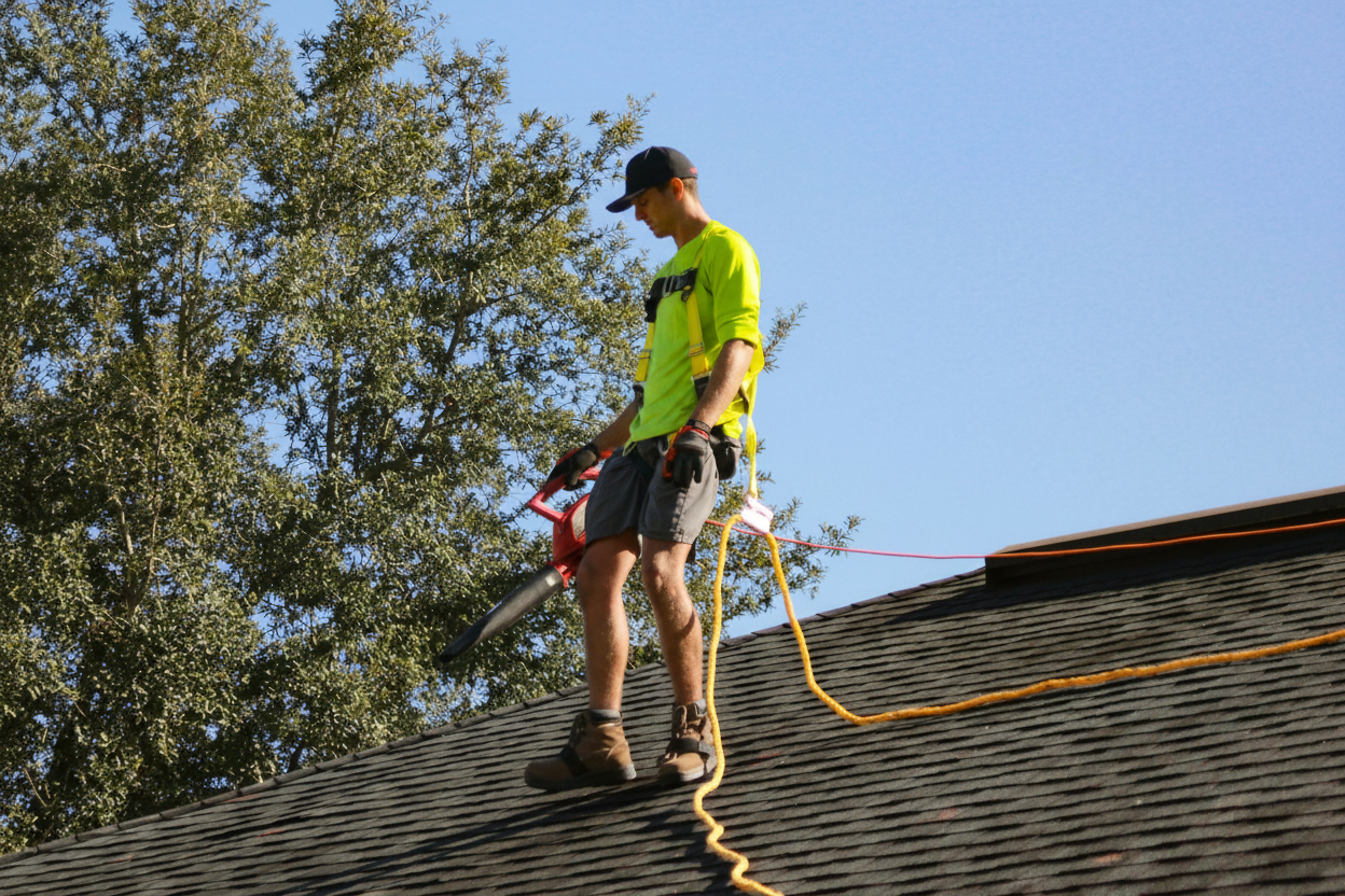 Homeowner inspecting a freshly cleaned tile roof, showing the results of proper maintenance and care
