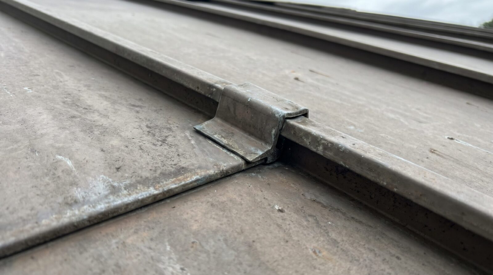 Close up of standing seam metal roof panels showing interlocking design