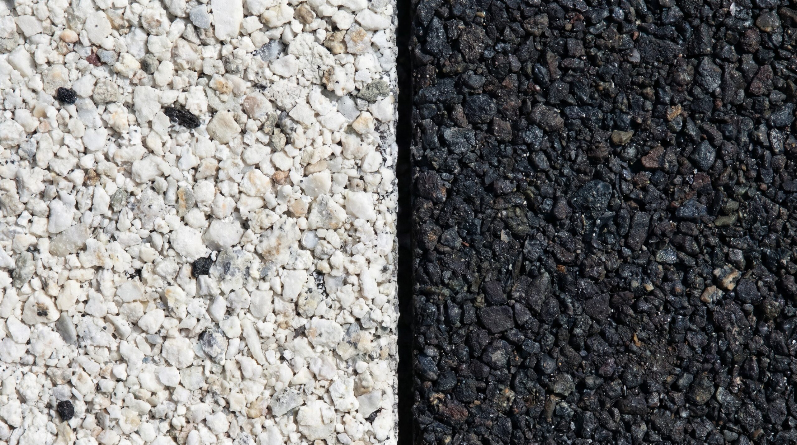 Close-up comparison of white shingles versus dark shingles showing granule texture and color difference